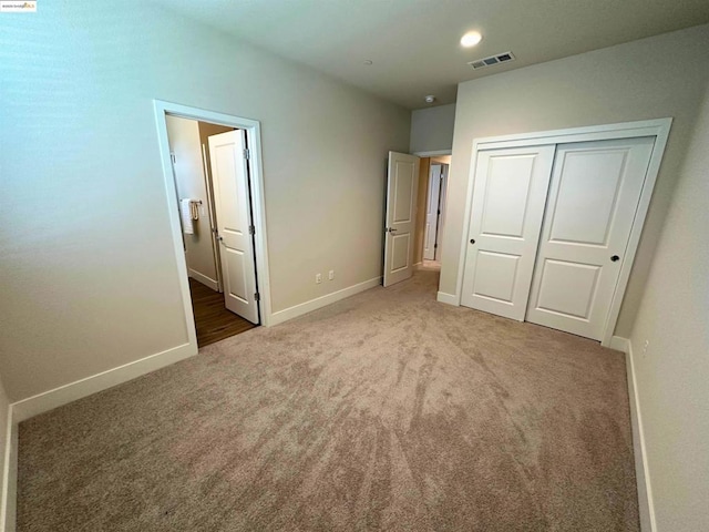 unfurnished bedroom with a closet and carpet floors