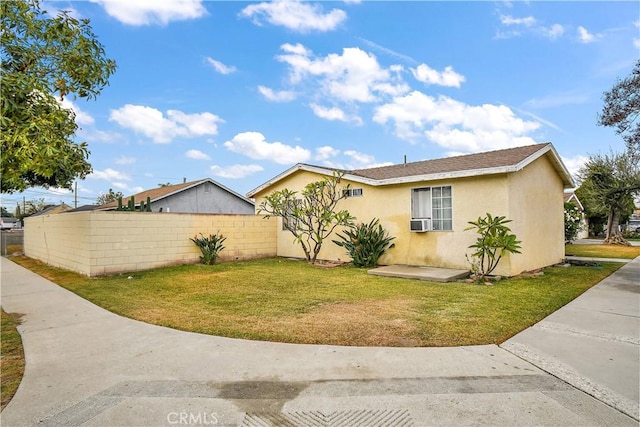 view of side of property with a lawn