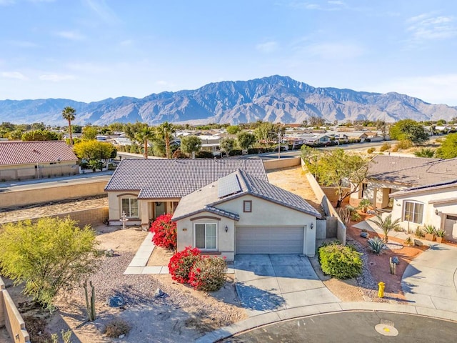 view of front of house featuring a mountain view and a garage