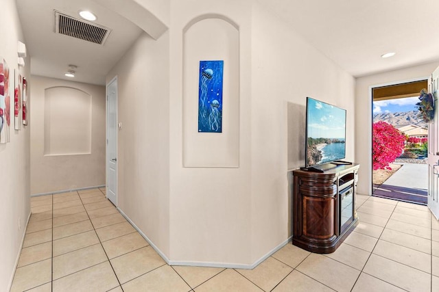 hallway featuring light tile patterned floors