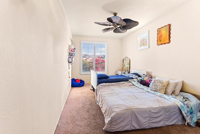 bedroom with ceiling fan and carpet flooring