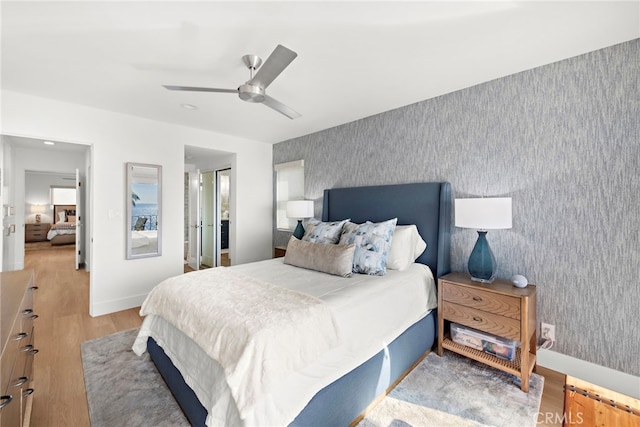 240 Moss St Unit 4, Laguna Beach, CA 92651 - bedroom with wallpapered walls, wood finished floors, ceiling fan, and an accent wall
