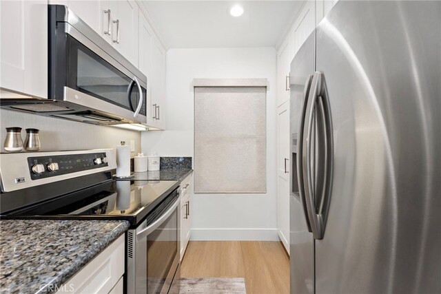 240 Moss St Unit 4, Laguna Beach, CA 92651 - kitchen featuring stainless steel appliances, light wood-type flooring, white cabinetry, dark stone counters, and recessed lighting