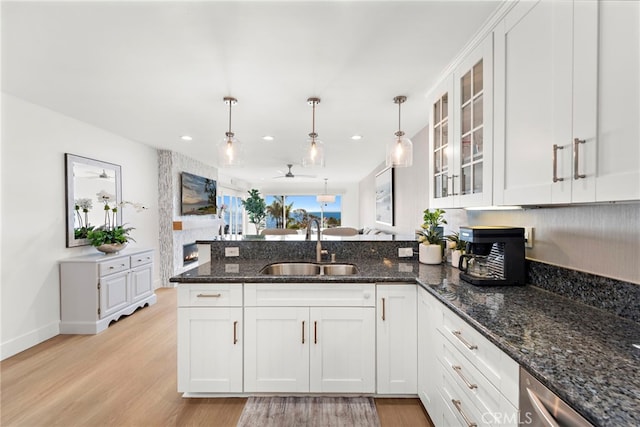240 Moss St Unit 4, Laguna Beach, CA 92651 - kitchen featuring a peninsula, light wood-style flooring, glass insert cabinets, white cabinetry, and recessed lighting