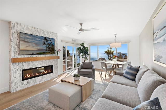 240 Moss St Unit 4, Laguna Beach, CA 92651 - living room featuring wood finished floors, a glass covered fireplace, ceiling fan, and baseboards