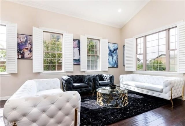 living room featuring plenty of natural light, dark wood-type flooring, ornamental molding, and lofted ceiling