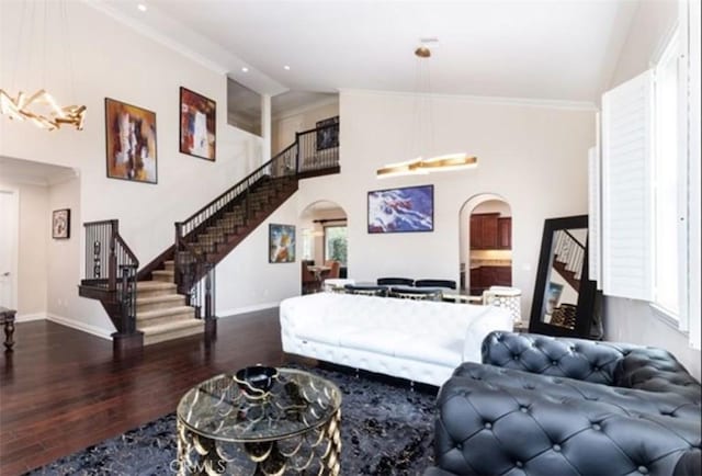 living room featuring high vaulted ceiling, crown molding, and hardwood / wood-style flooring