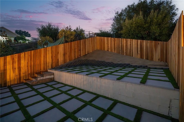 view of patio terrace at dusk