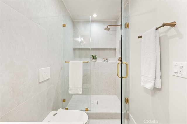 bathroom with toilet and a shower with shower door