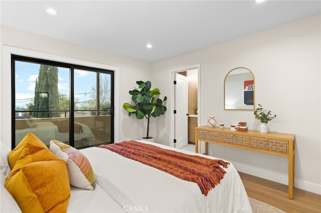 bedroom featuring access to outside and hardwood / wood-style floors