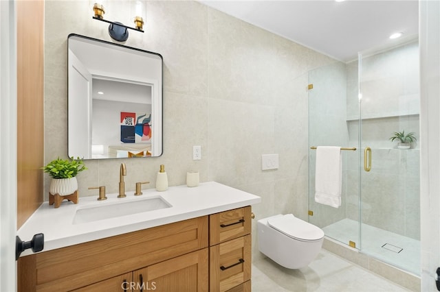 bathroom with toilet, tile walls, a shower with shower door, and vanity