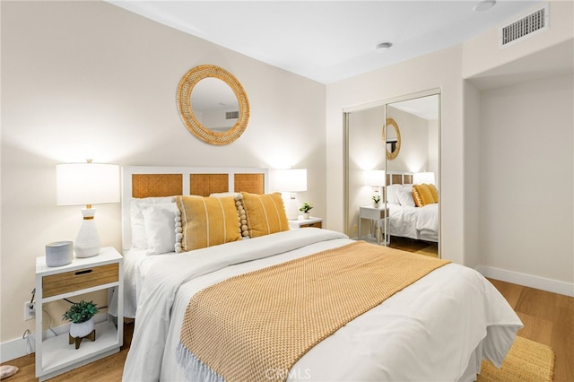 bedroom with a closet and hardwood / wood-style flooring