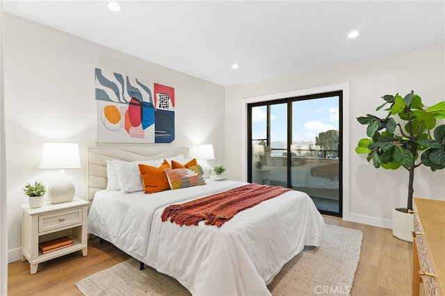 bedroom featuring access to exterior and light hardwood / wood-style flooring