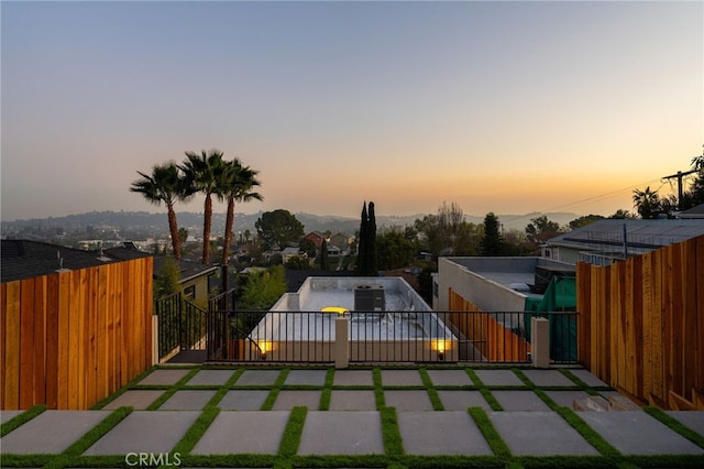 view of patio terrace at dusk