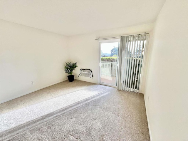 carpeted empty room with an AC wall unit