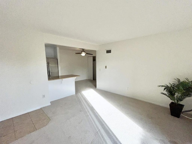 spare room with ceiling fan and carpet floors