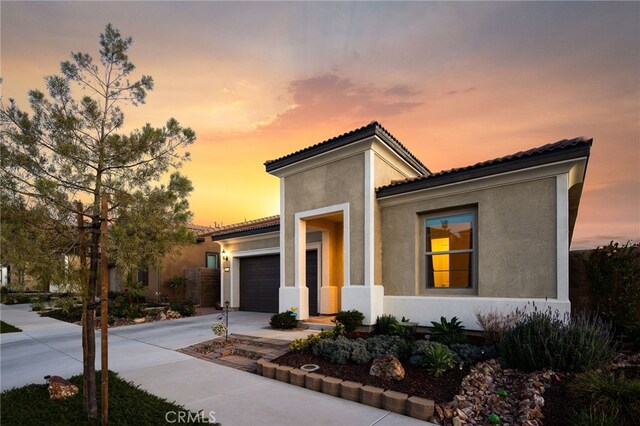 mediterranean / spanish house with a garage