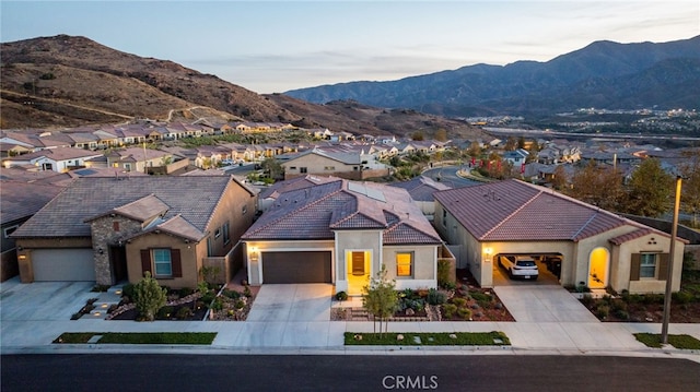 view of front of home with a mountain view and a garage