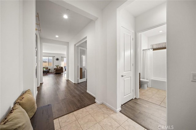 hallway featuring light tile patterned flooring