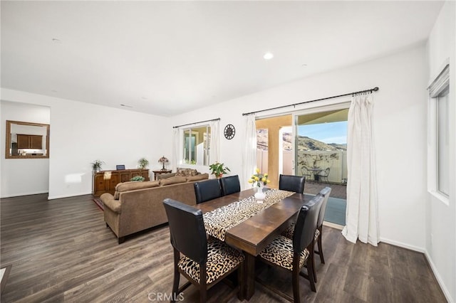 dining space with dark hardwood / wood-style floors