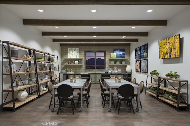 dining area featuring beam ceiling and dark hardwood / wood-style floors