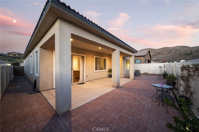 patio terrace at dusk with a mountain view