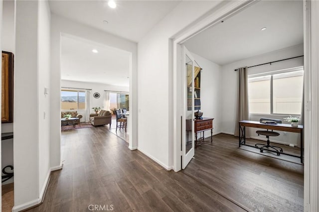 hallway with dark hardwood / wood-style flooring