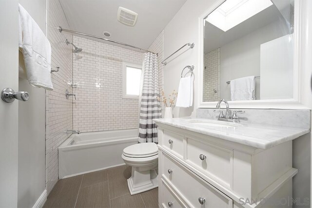 full bathroom with toilet, shower / bath combo, and vanity