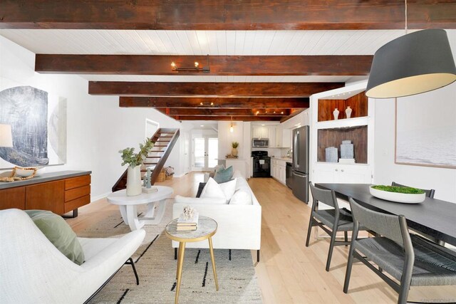 living room featuring beam ceiling and light wood-type flooring