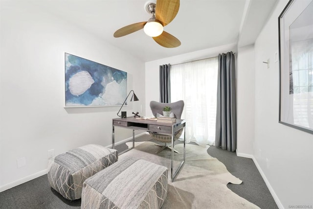 carpeted home office featuring ceiling fan