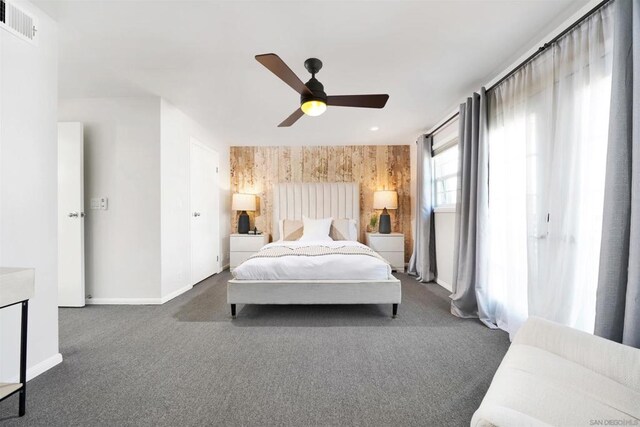 bedroom featuring ceiling fan and dark carpet