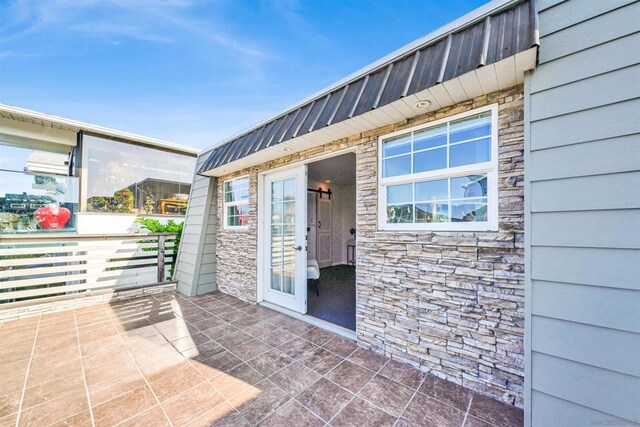 property entrance featuring a patio area