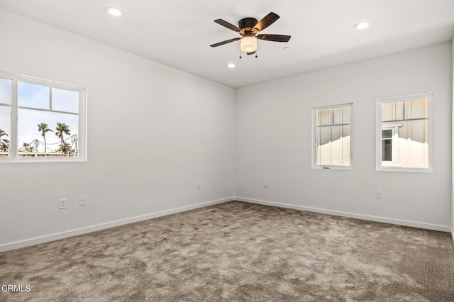 unfurnished room with ceiling fan and carpet flooring