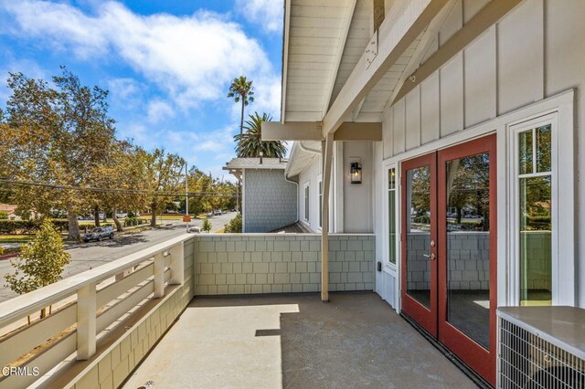 balcony featuring central AC unit and french doors