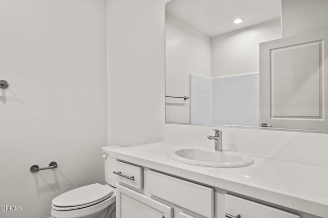 bathroom featuring toilet and vanity