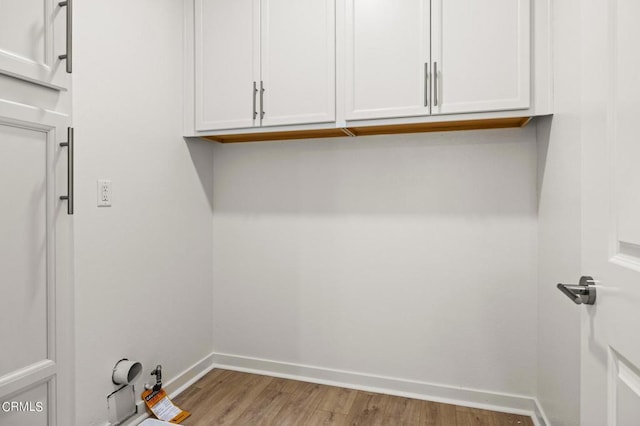 clothes washing area featuring light wood-type flooring