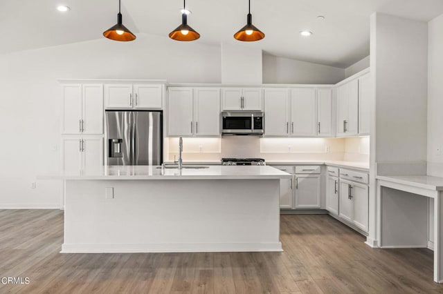 kitchen featuring decorative light fixtures, sink, white cabinets, and stainless steel appliances