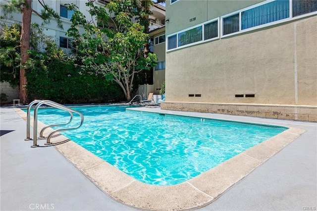 view of swimming pool with a patio area