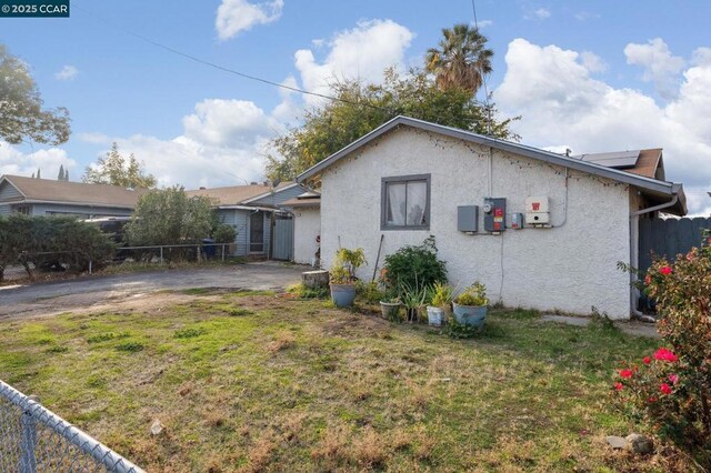 rear view of property with a yard