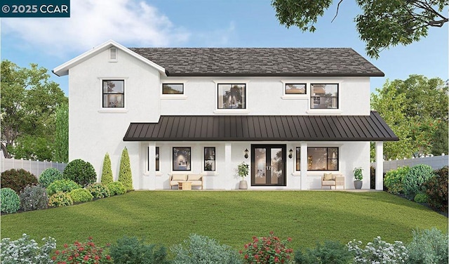 view of front facade with a front yard and french doors