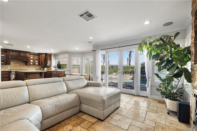 living room with french doors and crown molding