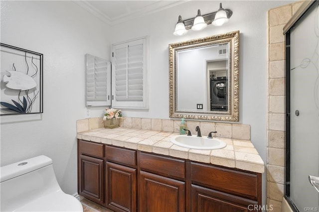 bathroom featuring toilet, crown molding, and vanity