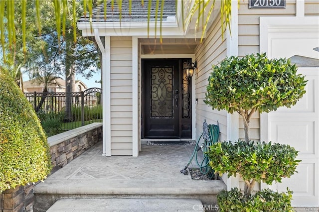 view of exterior entry with a balcony