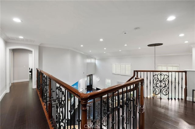 hall featuring dark wood-type flooring and ornamental molding