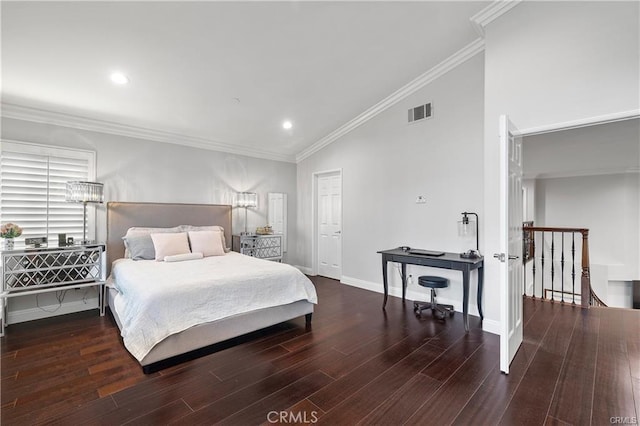 bedroom with dark hardwood / wood-style floors, ornamental molding, and vaulted ceiling