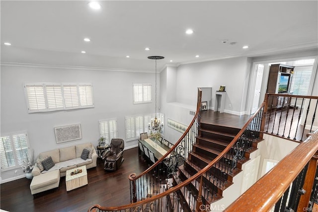 stairway with hardwood / wood-style flooring and ornamental molding