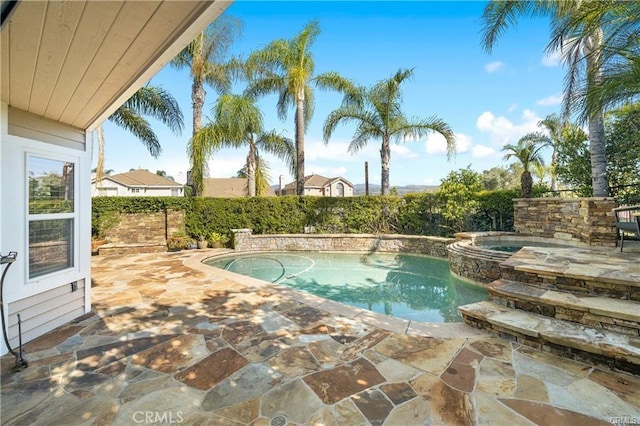 view of pool featuring a patio area and an in ground hot tub