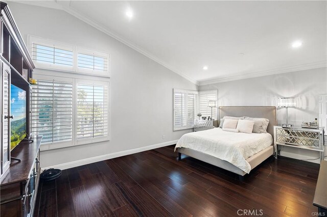 bedroom featuring vaulted ceiling, crown molding, and hardwood / wood-style flooring