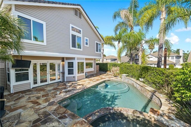 view of pool featuring french doors and a patio area