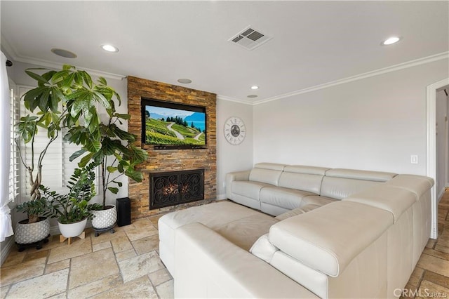 living room with ornamental molding and a stone fireplace